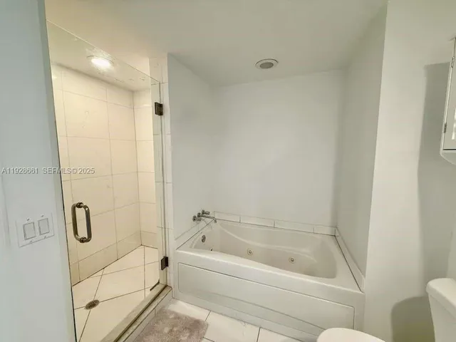 a bathroom with a bathtub and shower