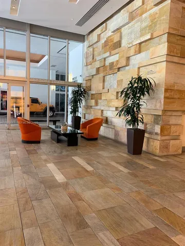 a building outdoor space with patio furniture and potted plants