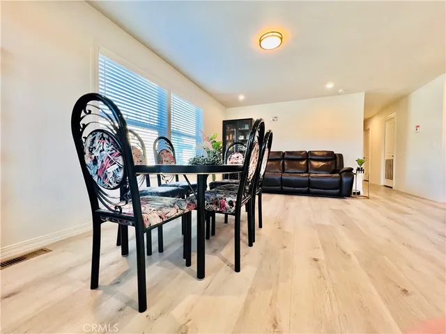 a dining room with furniture and a rug
