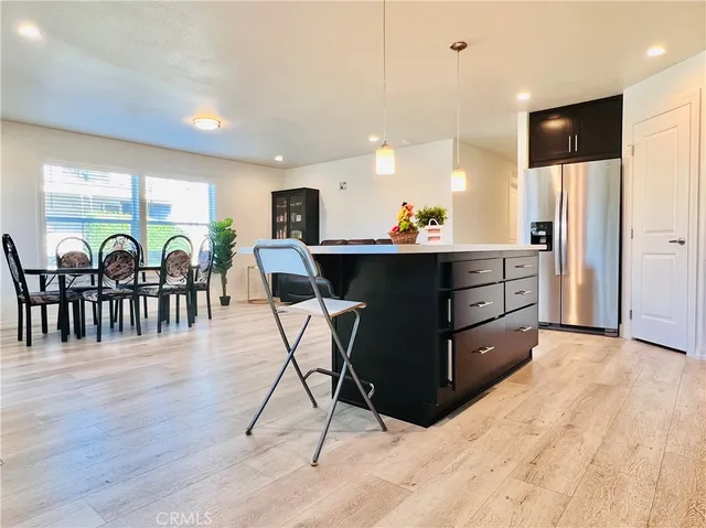 a kitchen with stainless steel appliances a microwave a sink and a refrigerator
