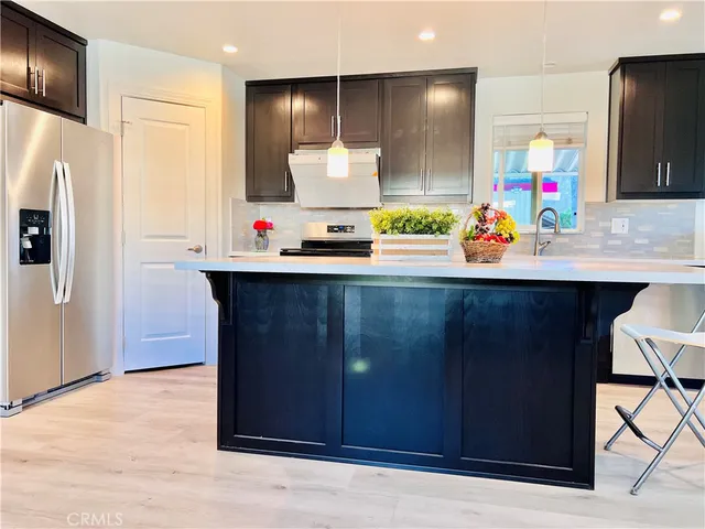 a kitchen with a sink a stove and refrigerator