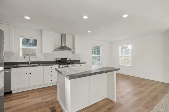 a kitchen with granite countertop a sink and a stove top oven