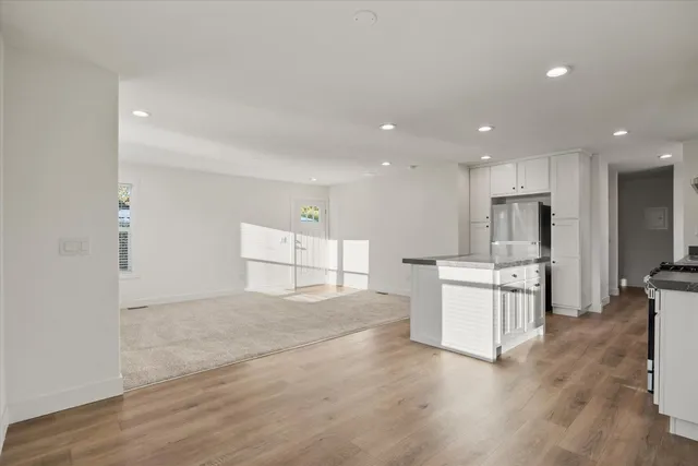 a view of kitchen with microwave and cabinets