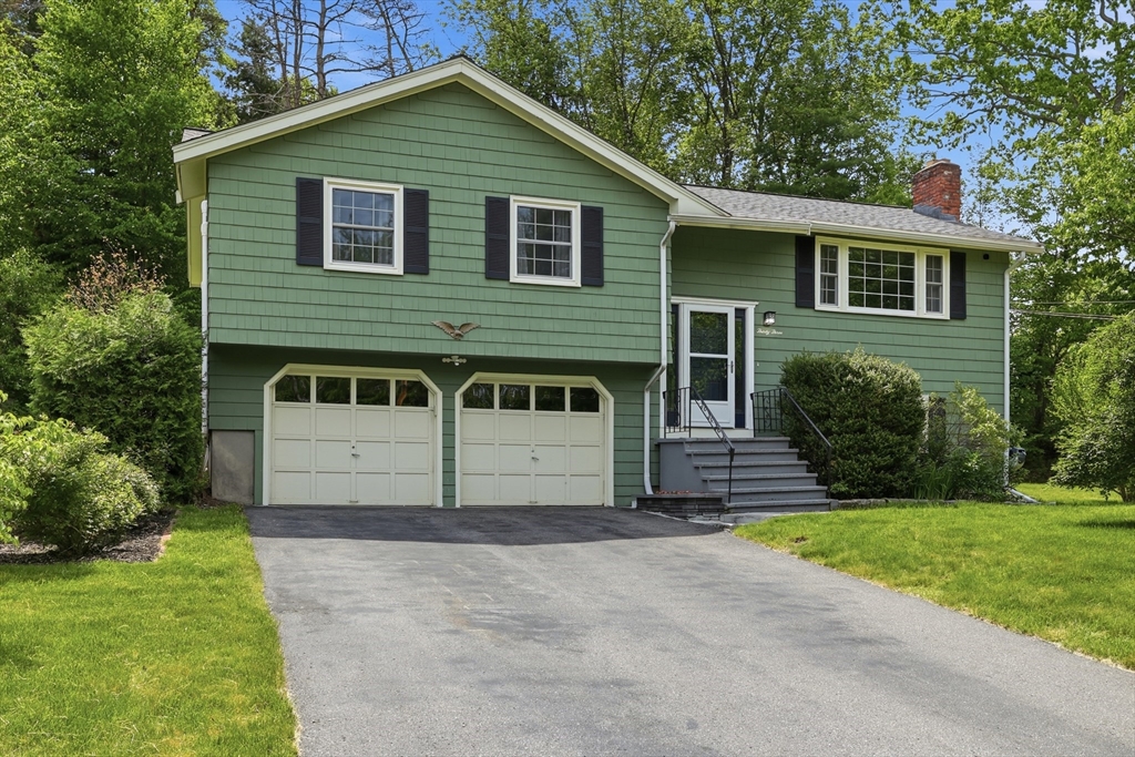 33 Simon Willard Road Acton, MA 01720 - Photo 1 of 42 a front view of a house with a yard and garage