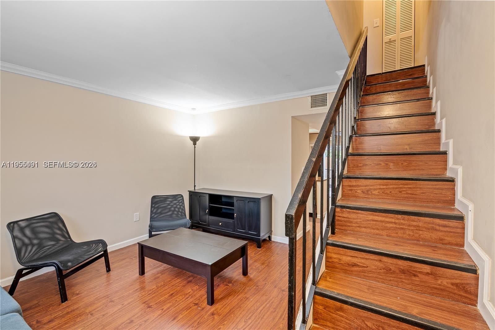 1927 Southwest 107th Avenue, Unit 306 Miami, FL 33165 - Photo 12 of 23 a living room with furniture and a wooden floor