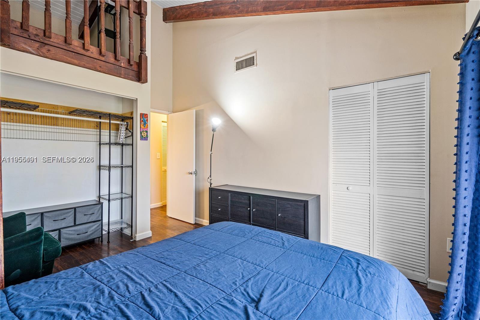 1927 Southwest 107th Avenue, Unit 306 Miami, FL 33165 - Photo 17 of 23 a bedroom with a bed and wooden floor