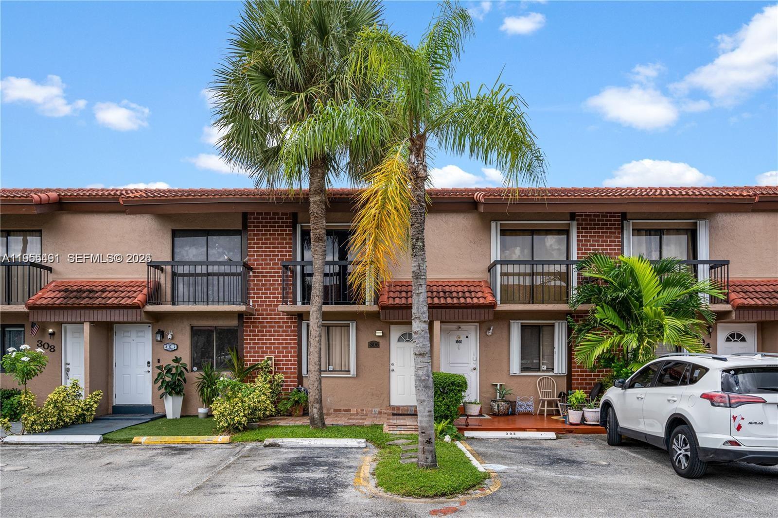 1927 Southwest 107th Avenue, Unit 306 Miami, FL 33165 - Photo 2 of 23 a view of a car park in front of a building