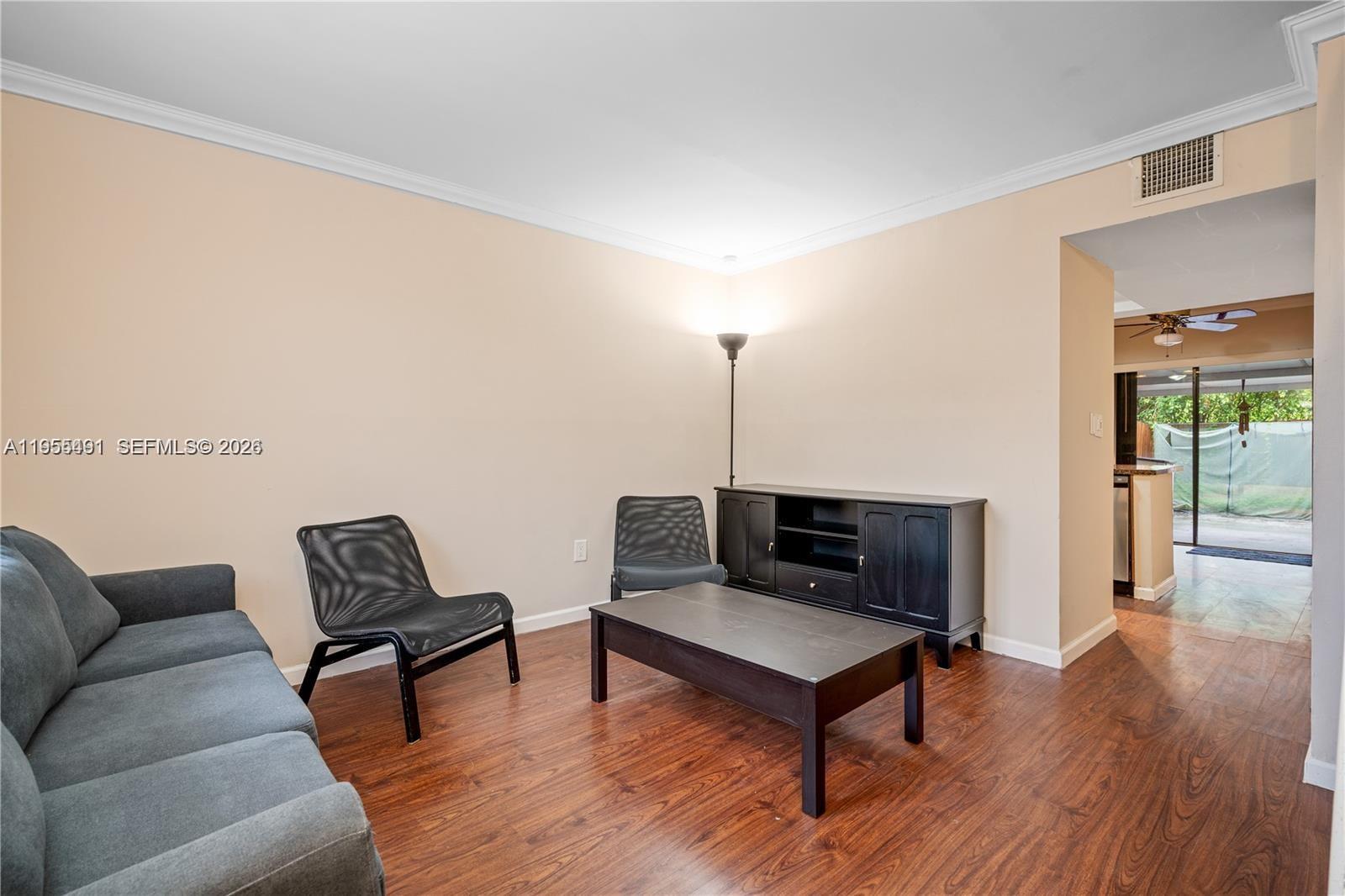 1927 Southwest 107th Avenue, Unit 306 Miami, FL 33165 - Photo 3 of 23 a living room with furniture and wooden floor