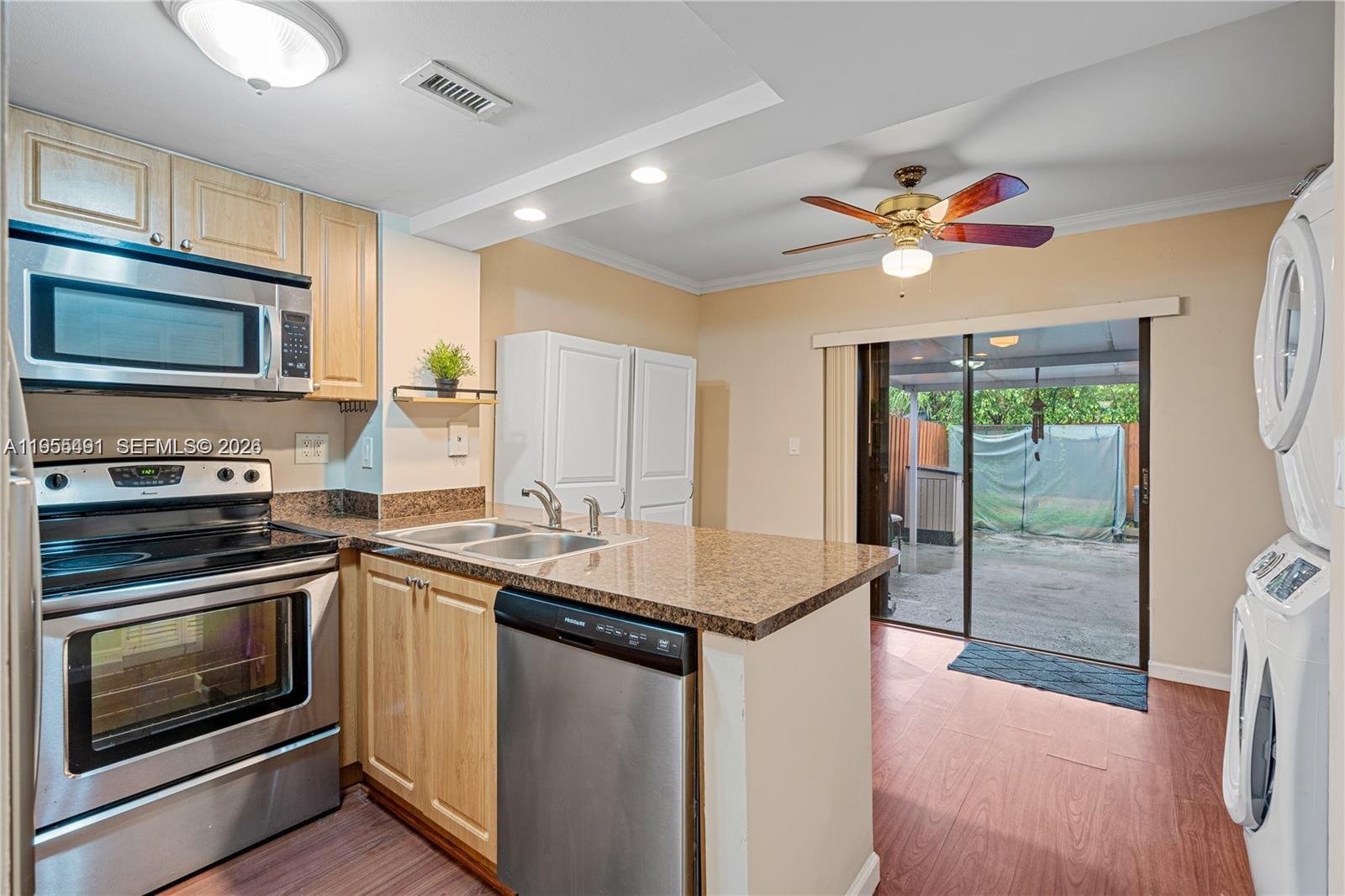 1927 Southwest 107th Avenue, Unit 306 Miami, FL 33165 - Photo 5 of 23 a kitchen with a stove a sink and a microwave