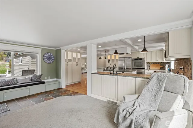 a living room with furniture a flat screen tv and a large window