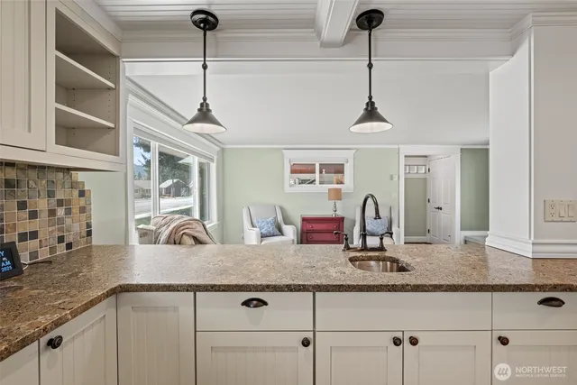 a kitchen with granite countertop a sink stainless steel appliances and cabinets