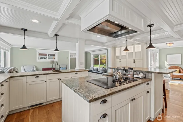 a kitchen with granite countertop a sink and cabinets