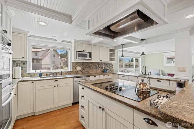 a kitchen with a sink stove and cabinets