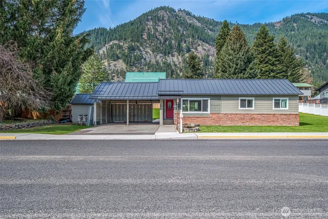 a front view of a house with a garden