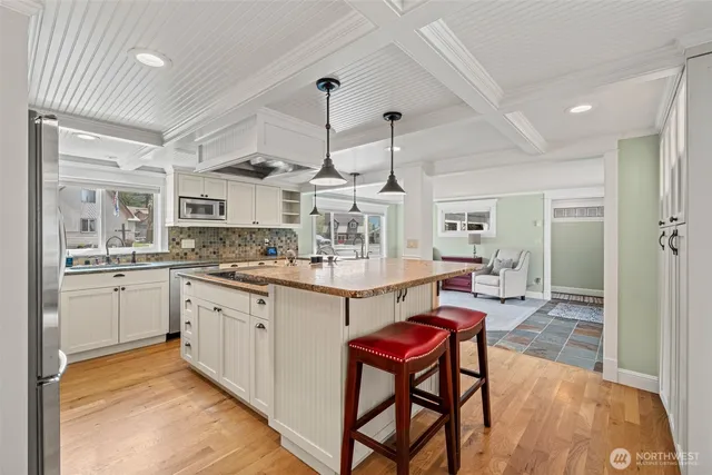 a kitchen with stainless steel appliances kitchen island granite countertop a sink and cabinets