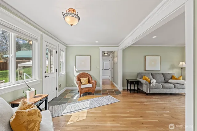 a living room with furniture gym equipment and a large window