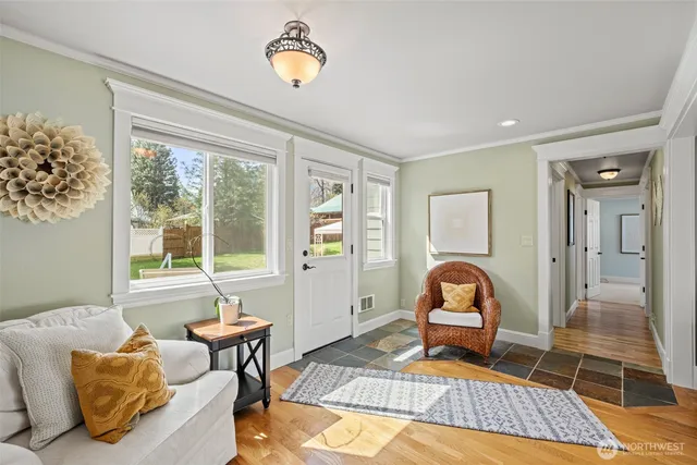 a living room with furniture a rug and a large window