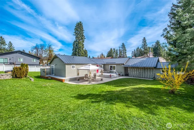 a view of a house with a yard and sitting area