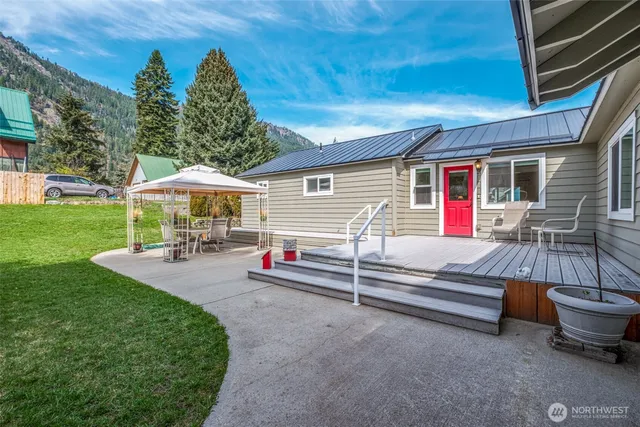a view of backyard with seating area and green space