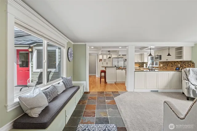 a living room with furniture and a dining table with kitchen view