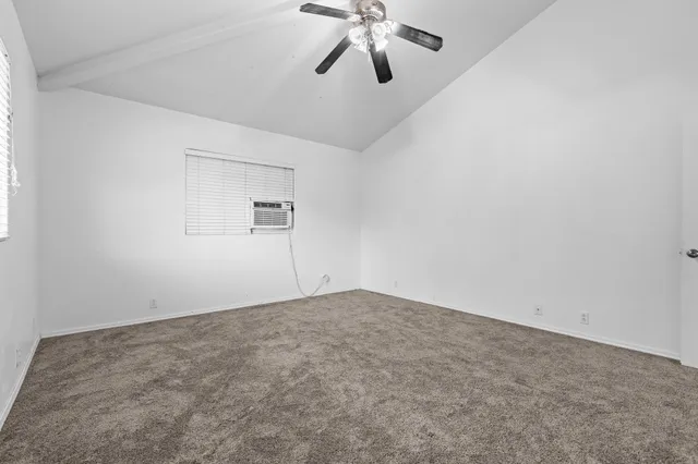 an empty room with a empty space and ceiling fan