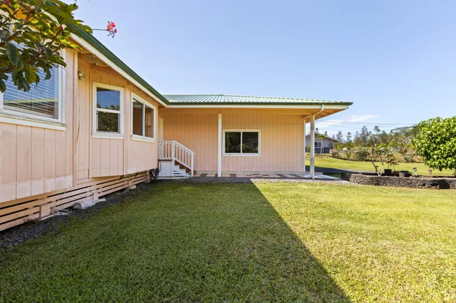 a backyard of a house with wooden floor and fence