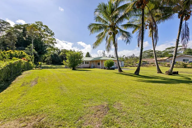 a view of swimming pool with table and chairs