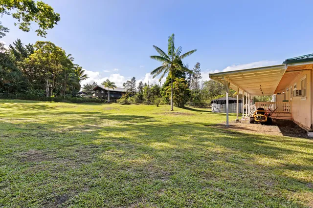 a view of a swimming pool and a yard