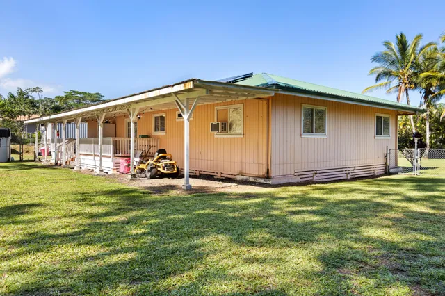 a view of a backyard with table and chairs and potted plants