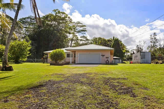 a front view of house with yard and trees