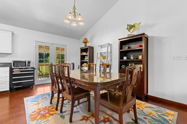 a dining room with furniture and wooden floor