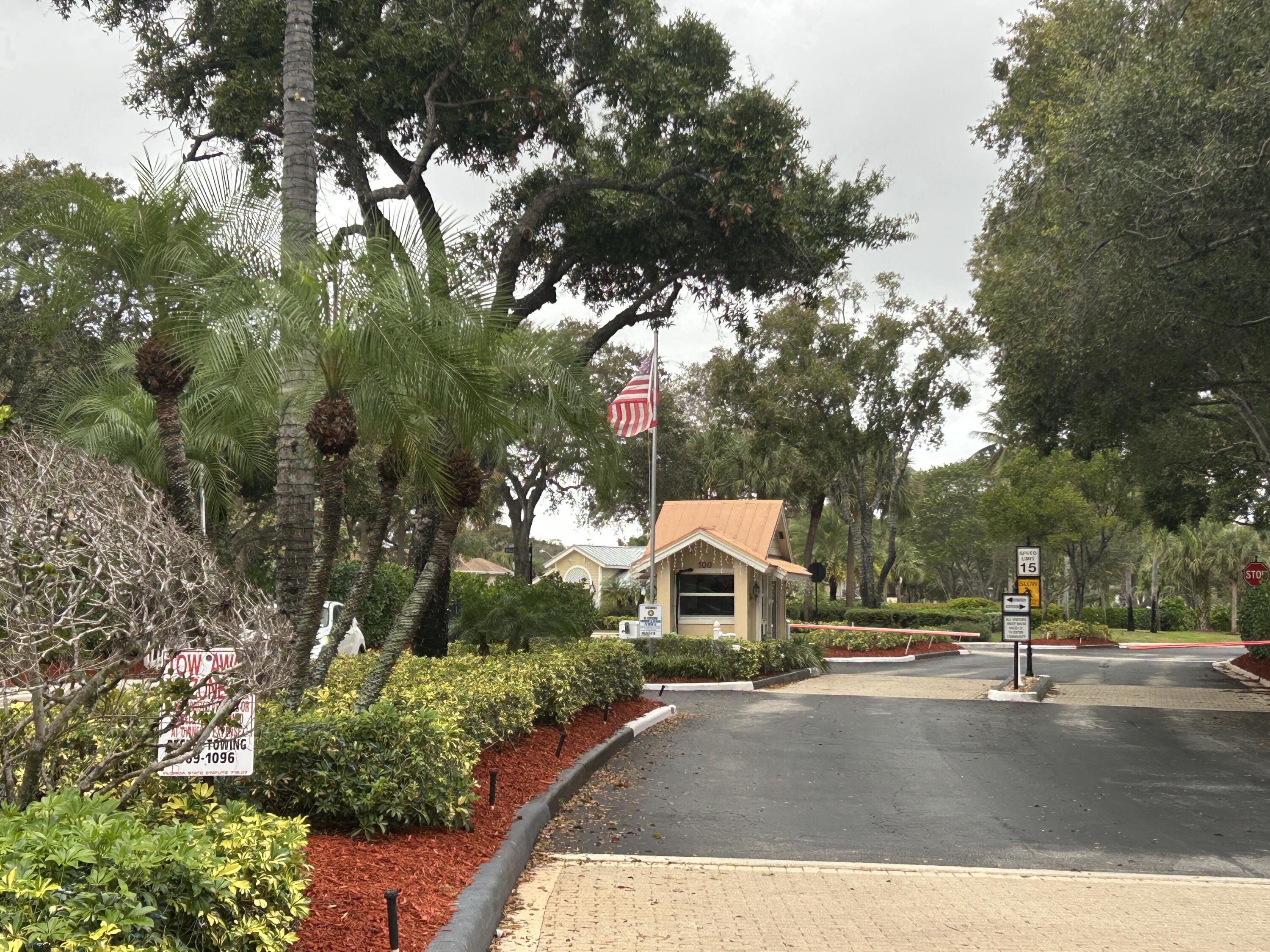 4802 Roxbury Court Boynton Beach, FL 33436 - Photo 14 of 23 a view of street with sign board and trees