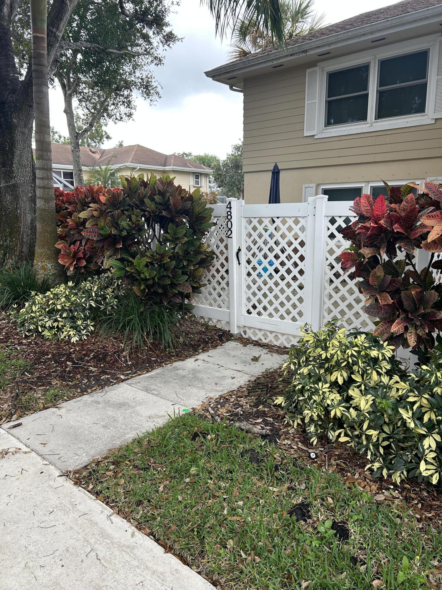 4802 Roxbury Court Boynton Beach, FL 33436 - Photo 22 of 23 a view of a house with a flower garden