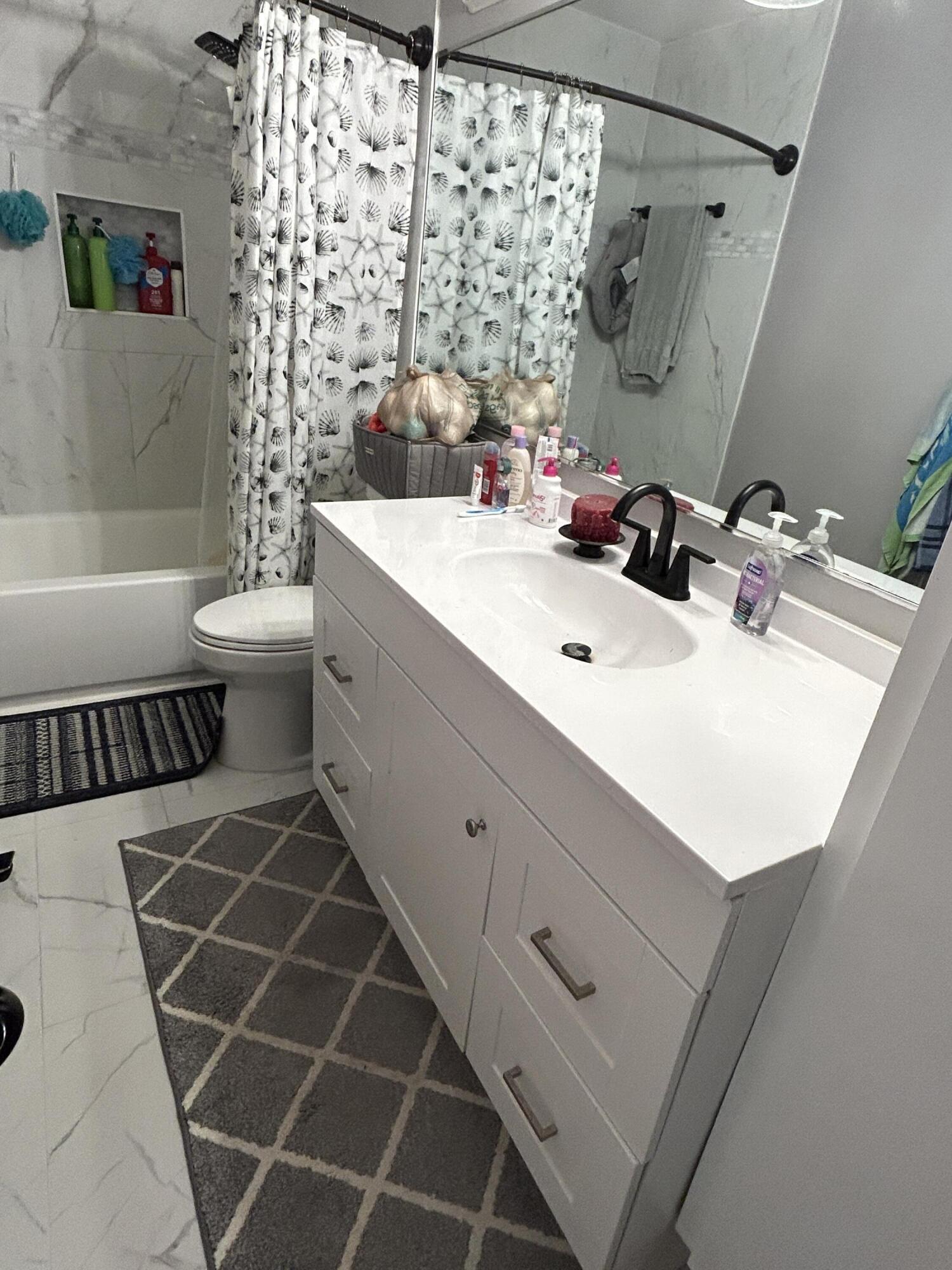 4802 Roxbury Court Boynton Beach, FL 33436 - Photo 8 of 23 a bathroom with a double vanity sink mirror and toilet
