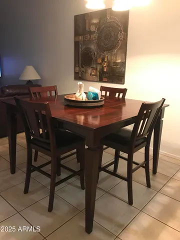 a view of a dining room with furniture and window