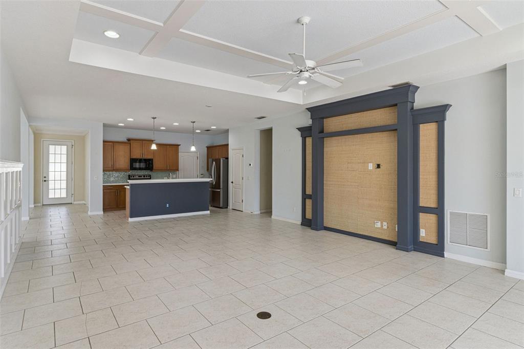 5312 Tide Point Way Bradenton, FL 34208 - Photo 13 of 40 an empty room with kitchen view and a ceiling fan