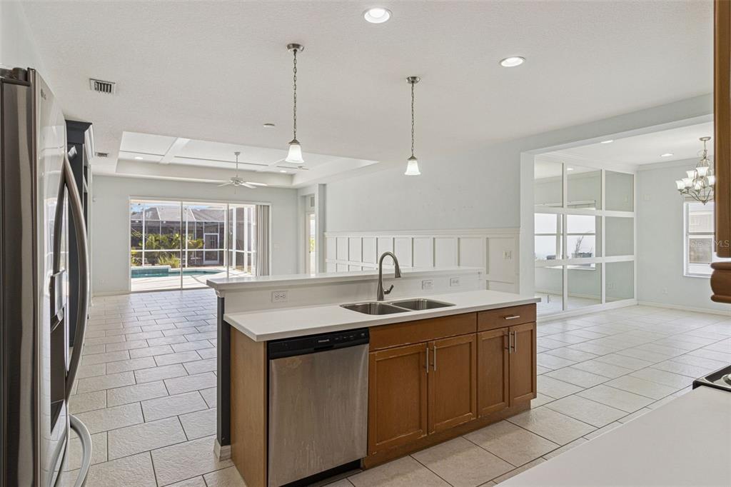 5312 Tide Point Way Bradenton, FL 34208 - Photo 15 of 40 a kitchen with stainless steel appliances granite countertop a sink and a refrigerator