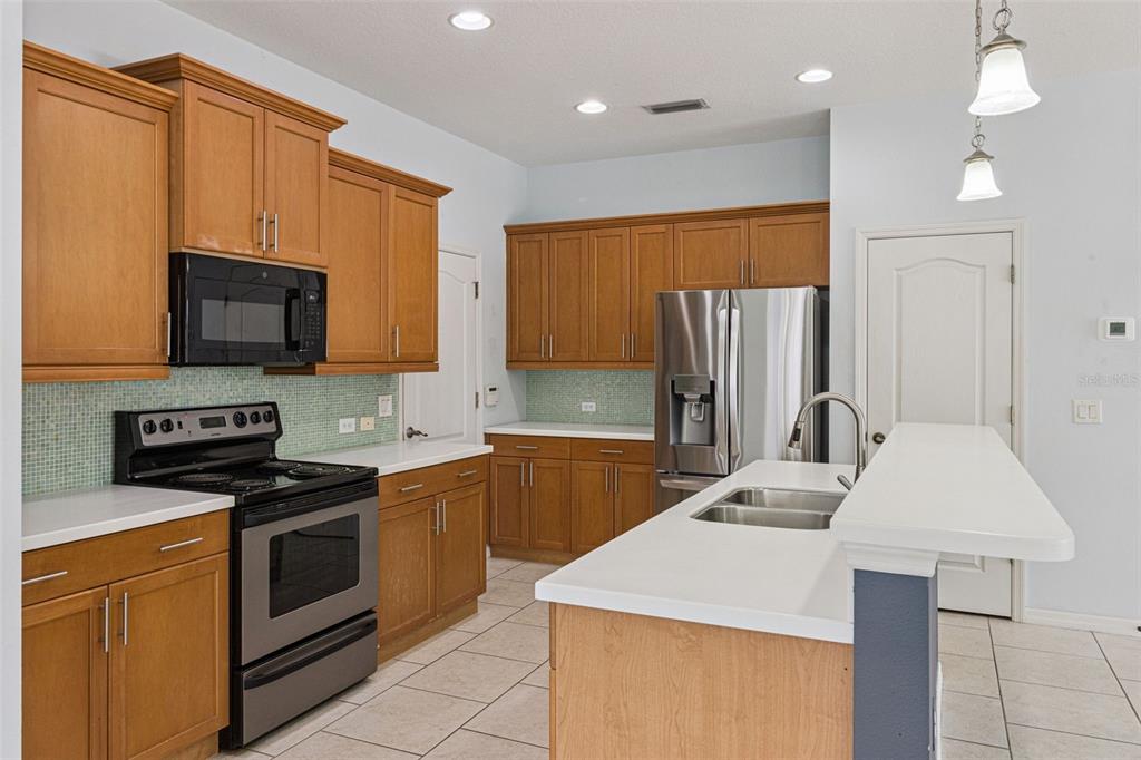 5312 Tide Point Way Bradenton, FL 34208 - Photo 17 of 40 a kitchen with a sink a stove and refrigerator