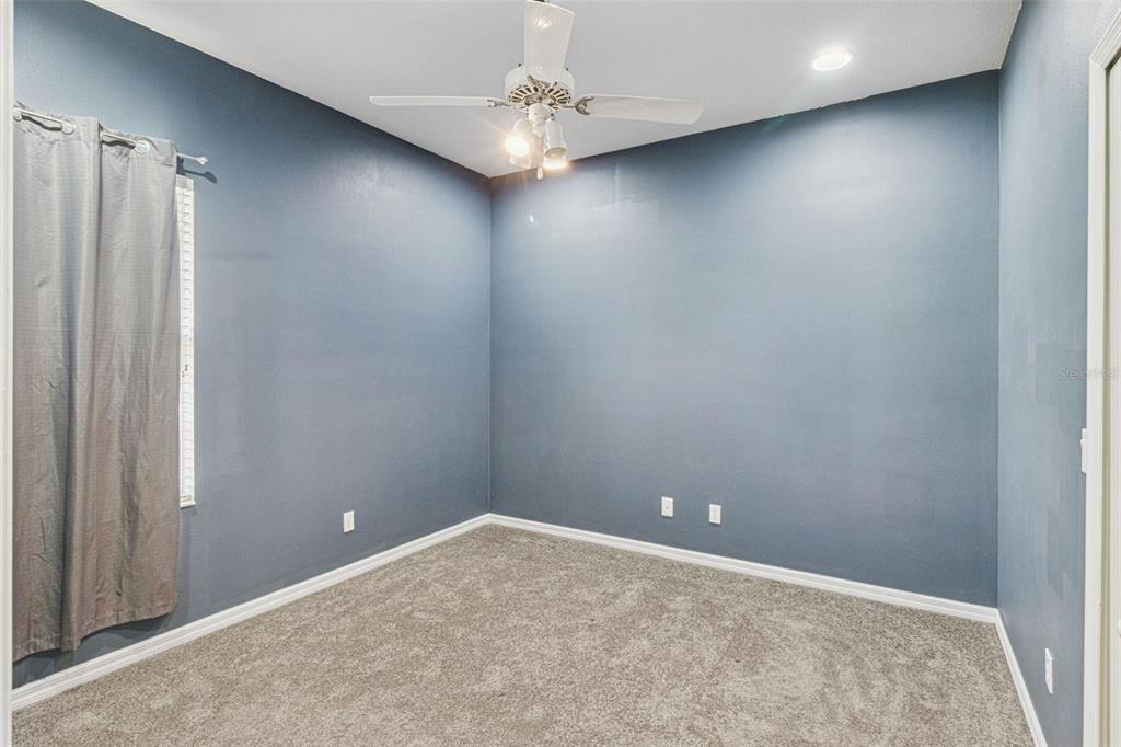 5312 Tide Point Way Bradenton, FL 34208 - Photo 23 of 40 an empty room with a ceiling fan and carpet