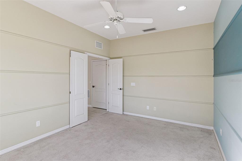 5312 Tide Point Way Bradenton, FL 34208 - Photo 26 of 40 an empty room with closet and a ceiling fan