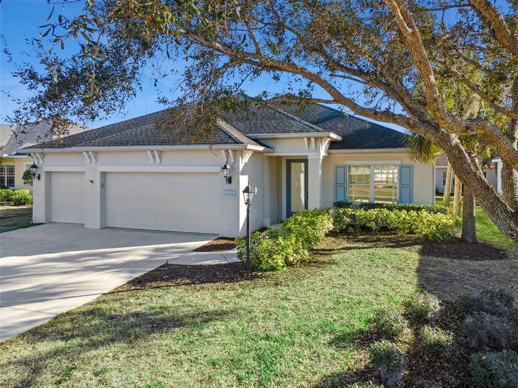 5312 Tide Point Way Bradenton, FL 34208 - Photo 3 of 40 a front view of a house with garden