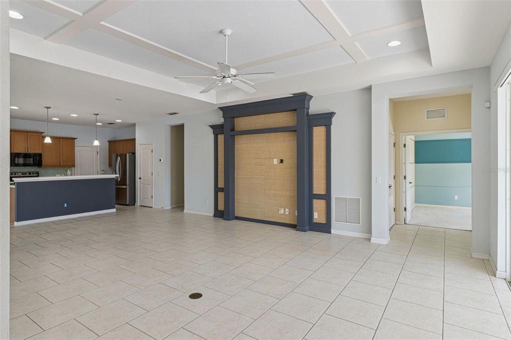 5312 Tide Point Way Bradenton, FL 34208 - Photo 8 of 40 an empty room with a chandelier fan and kitchen view
