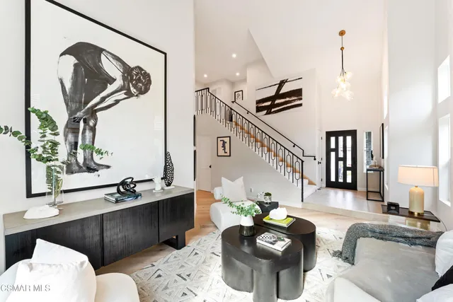 a living room with furniture and paintings on the wall