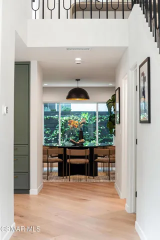 a room with large window and wooden floor