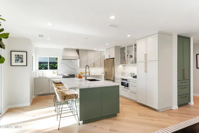 a view of kitchen island a sink and living room