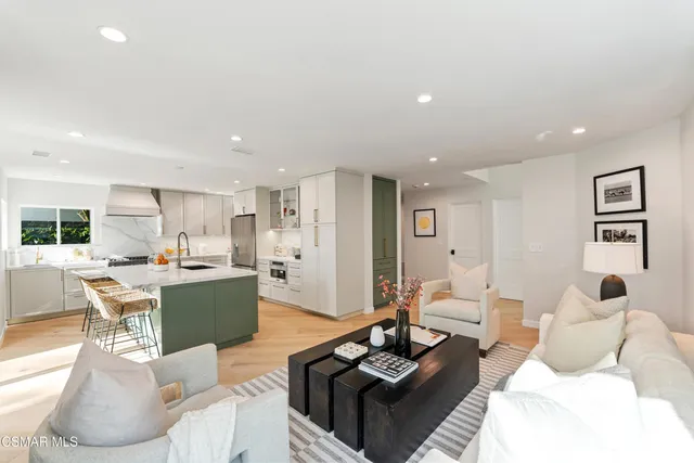 a living room with furniture a rug and a large window