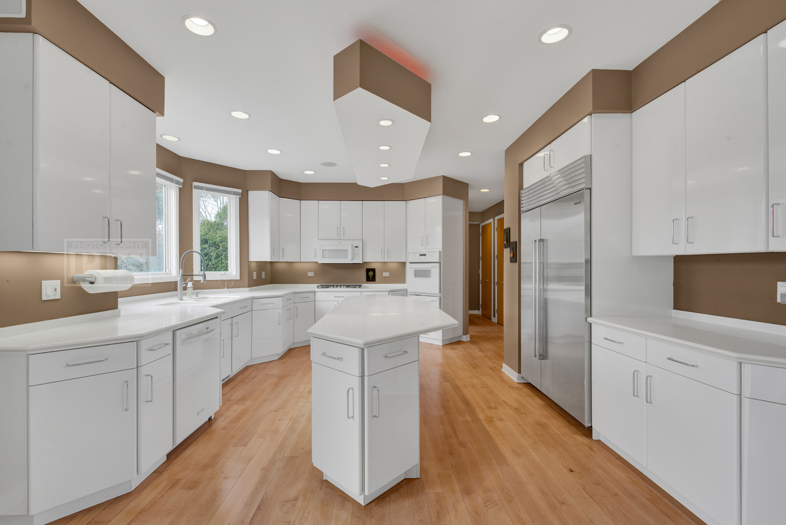 2067 Sheridan Road Buffalo Grove, IL 60089 - Photo 15 of 53 a large kitchen with stainless steel appliances kitchen island a large counter top and a refrigerator