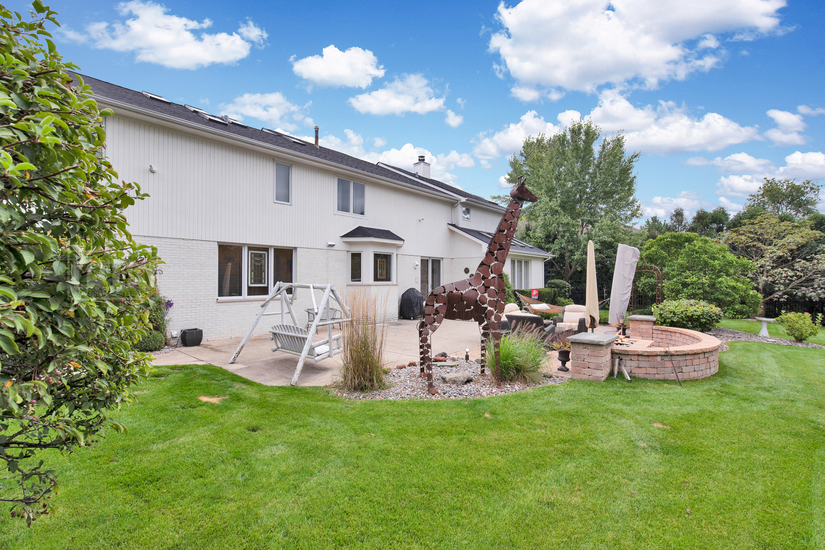2067 Sheridan Road Buffalo Grove, IL 60089 - Photo 44 of 53 a view of a house with backyard sitting area and garden