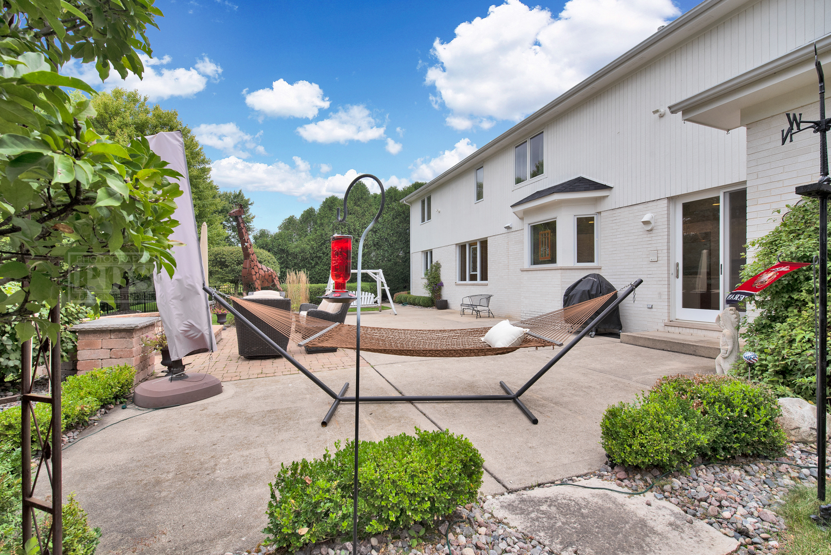 2067 Sheridan Road Buffalo Grove, IL 60089 - Photo 50 of 53 a view of a white house with swimming pool and sitting area