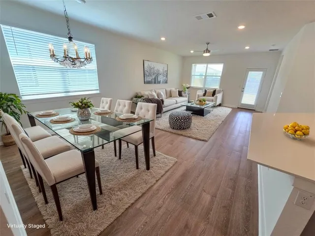 a view of a dining room with furniture and wooden floor